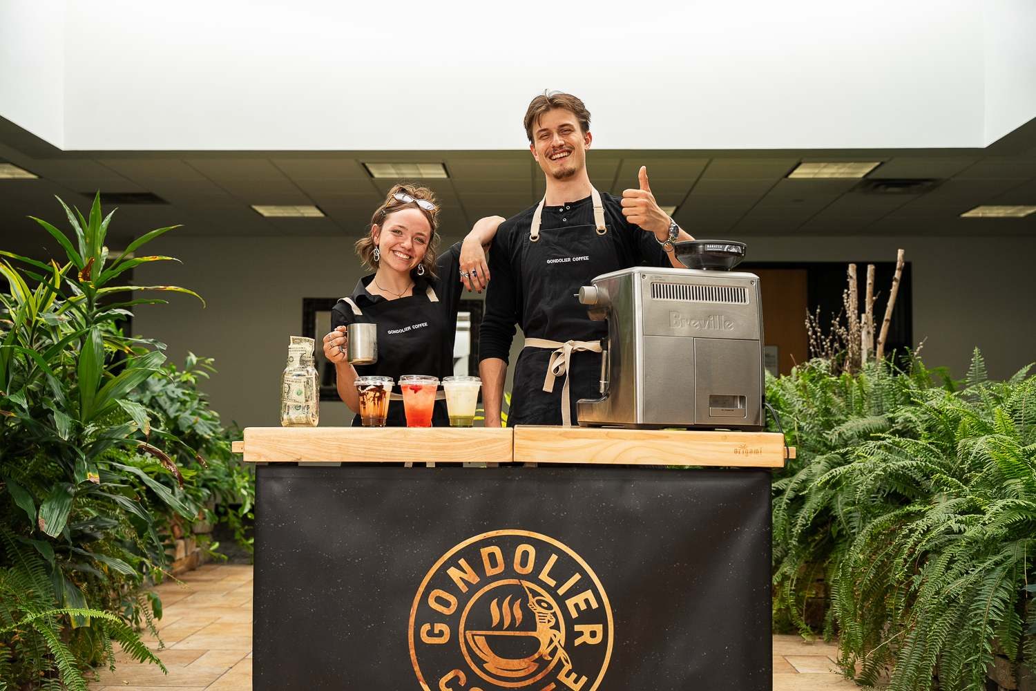 Gondolier Coffee baristas serving handcrafted espresso drinks from their branded mobile cart at a Minneapolis corporate event
