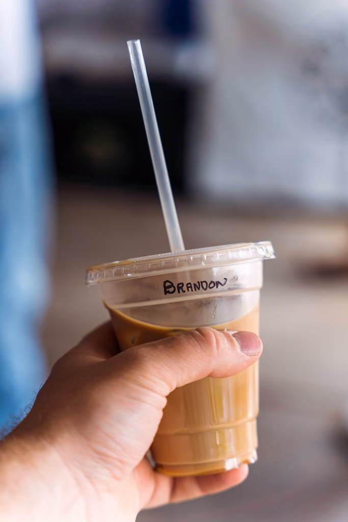 Hand-held iced specialty coffee at an outdoor Minneapolis event