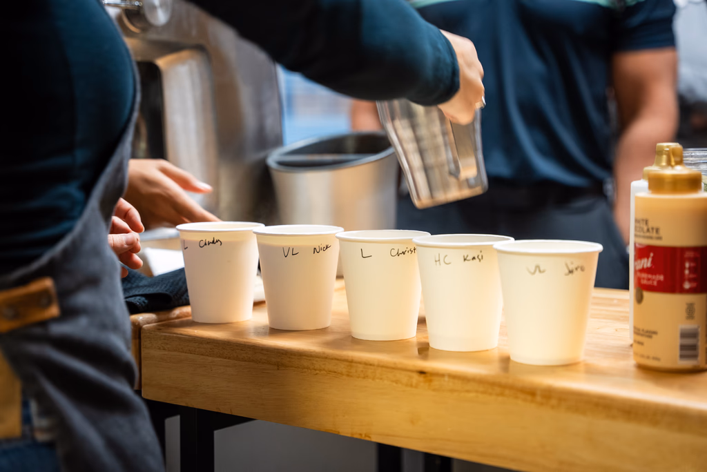 A row of personalized handcrafted coffee orders lined up on the Gondolier Coffee cart at a Twin Cities event