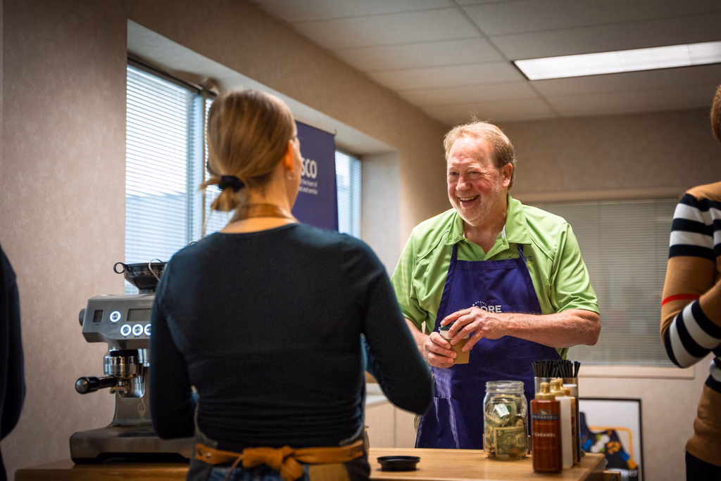 Barista serving coffee to guests at a Minneapolis indoor event