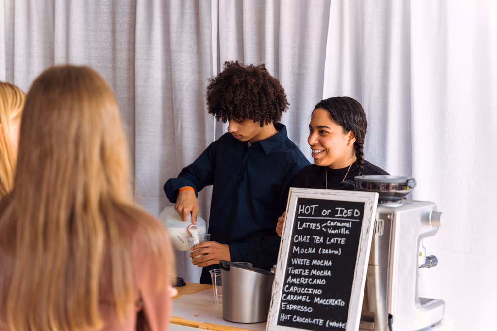Guests at the Gondolier Coffee espresso bar with a chalkboard menu