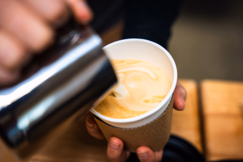 Professional barista pouring latte art at a hired mobile espresso bar in Minneapolis