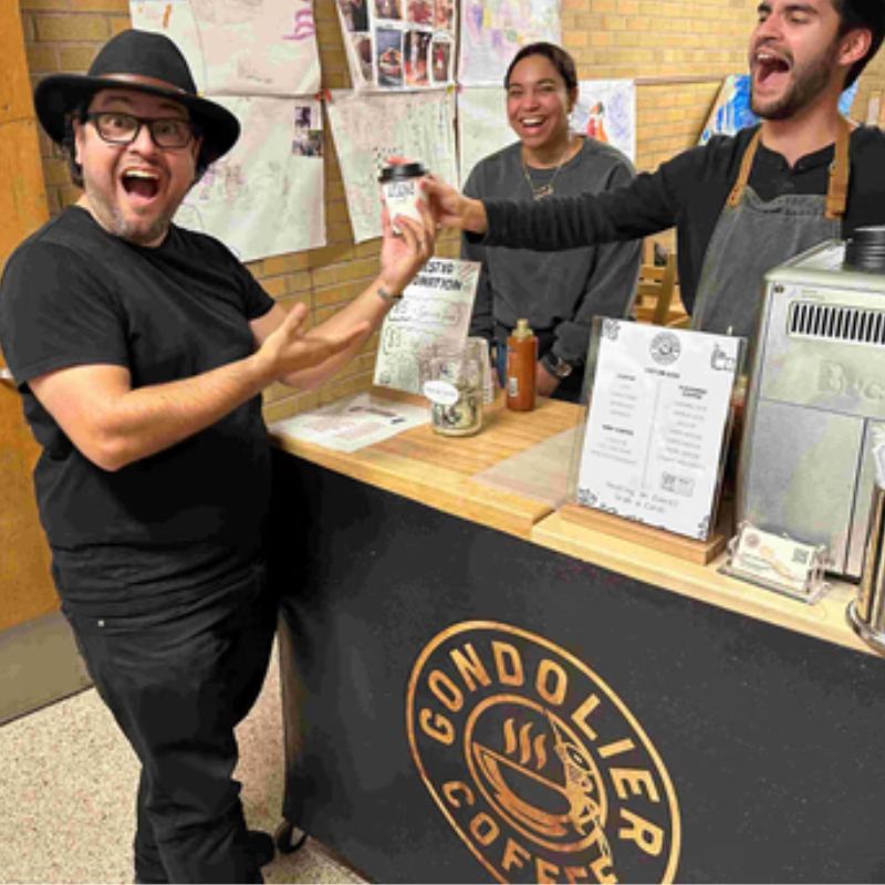 Guest receiving a handcrafted coffee from the Gondolier Coffee mobile bar