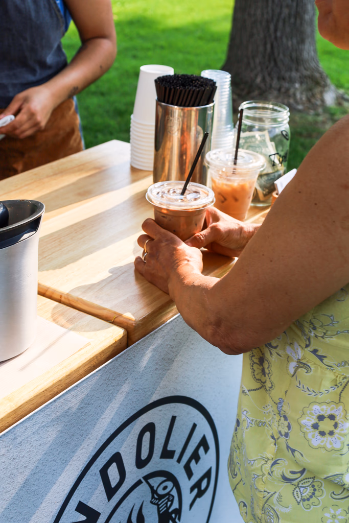 Guest holding an iced coffee at a Twin Cities catered event