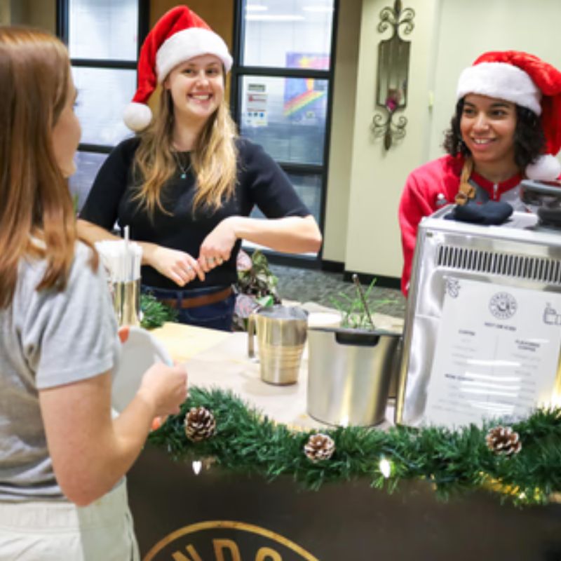 Holiday coffee catering with guests in Santa hats at a Minneapolis party
